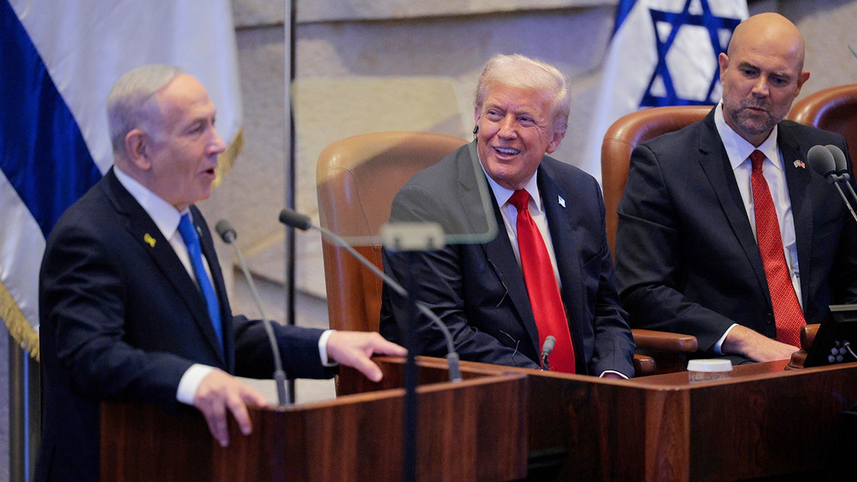Trump sitting and listening as Netanyahu speaks at the Knesset