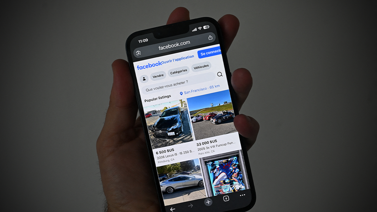 Person holding a smartphone displaying Facebook Marketplace listings