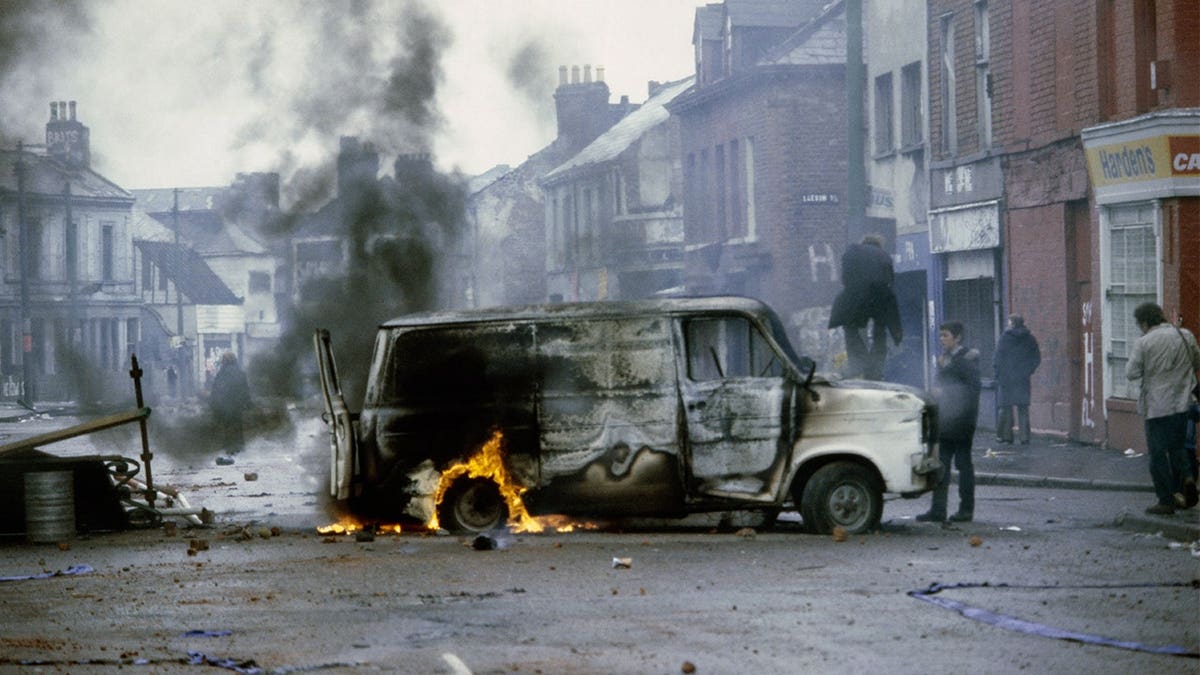 A van burns in a Belfast street during unrest in Northern Ireland in 1981.