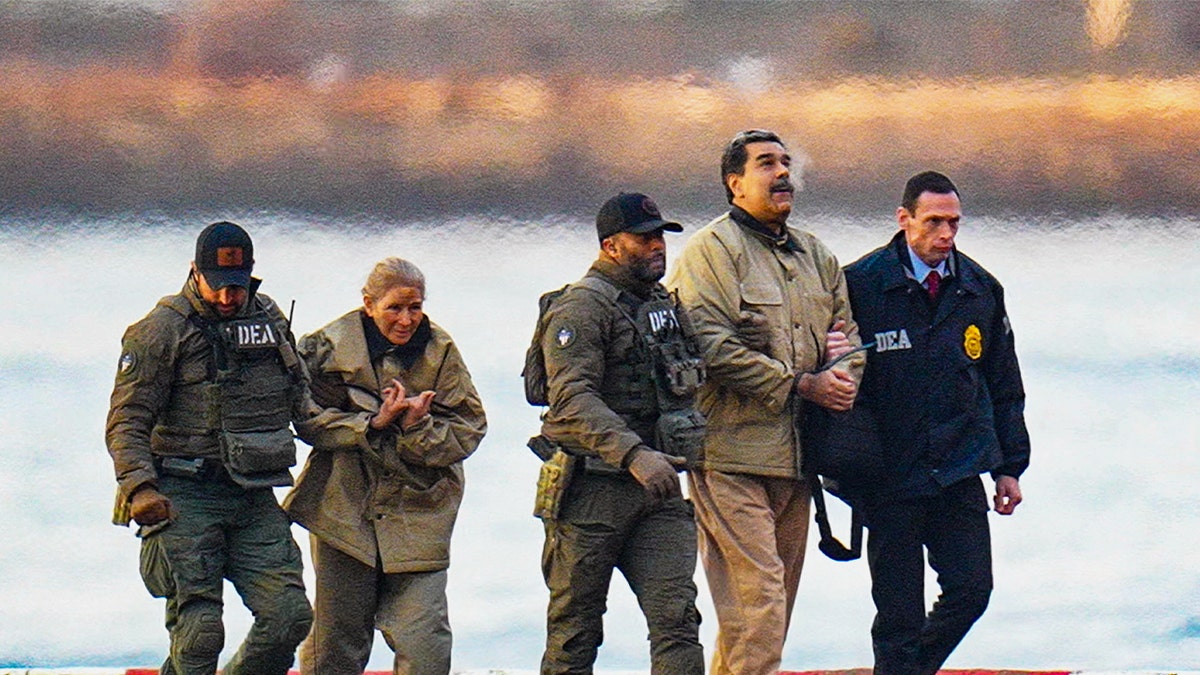 Nicolas Maduro and his wife, Cilia Flores, are seen in handcuffs after landing at a Manhattan helipad, escorted by heavily armed Federal agents as they make their way into an armored car en route to a Federal courthouse in Manhattan on January 5, 2026 in New York City.