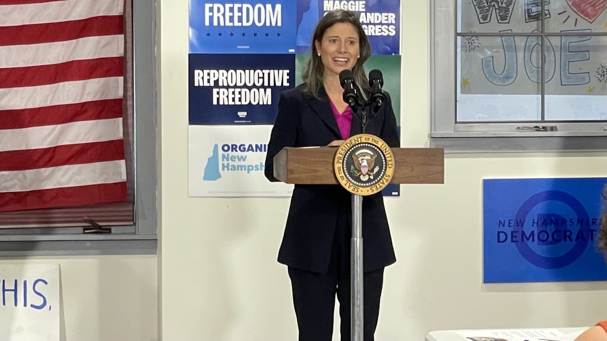 Maggie Goodlander standing at podium