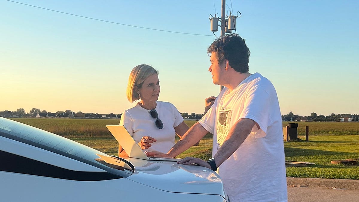 Mariana van Zeller and Arman stand behind a car in Los Angeles.