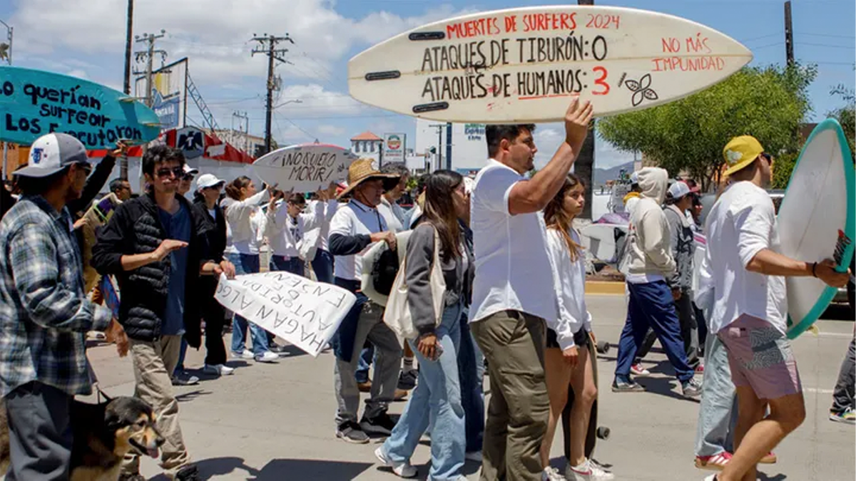 Locals march to protest the disappearance of foreign surfers in Ensenada, Mexico, Sunday, May 5, 2024