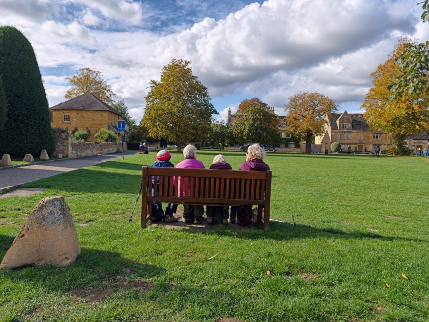 Image of four people sitting on a bench