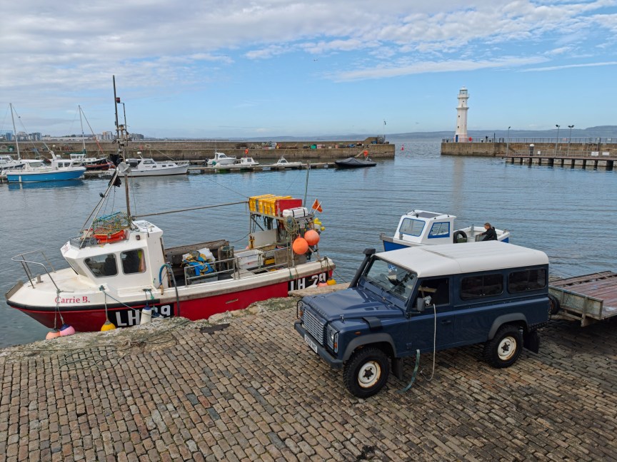 Image of a car next to a harbor
