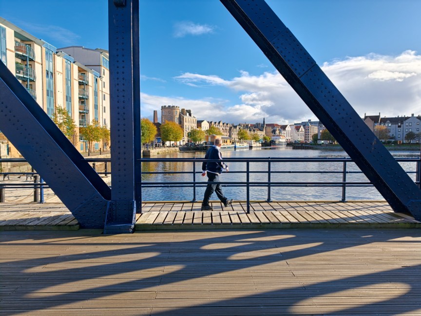 Image of a person walking over a bridge