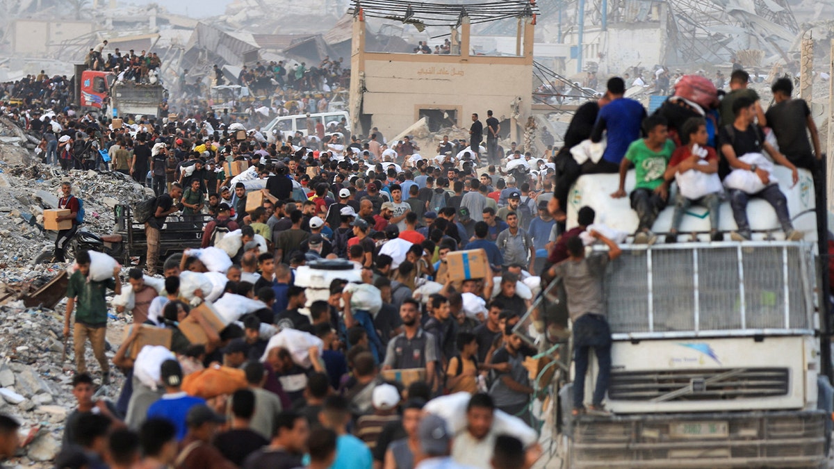 Palestinians carry aid supplies, that entered Gaza on trucks through Israel, in Beit Lahia, in the northern Gaza Strip July 29, 2025.