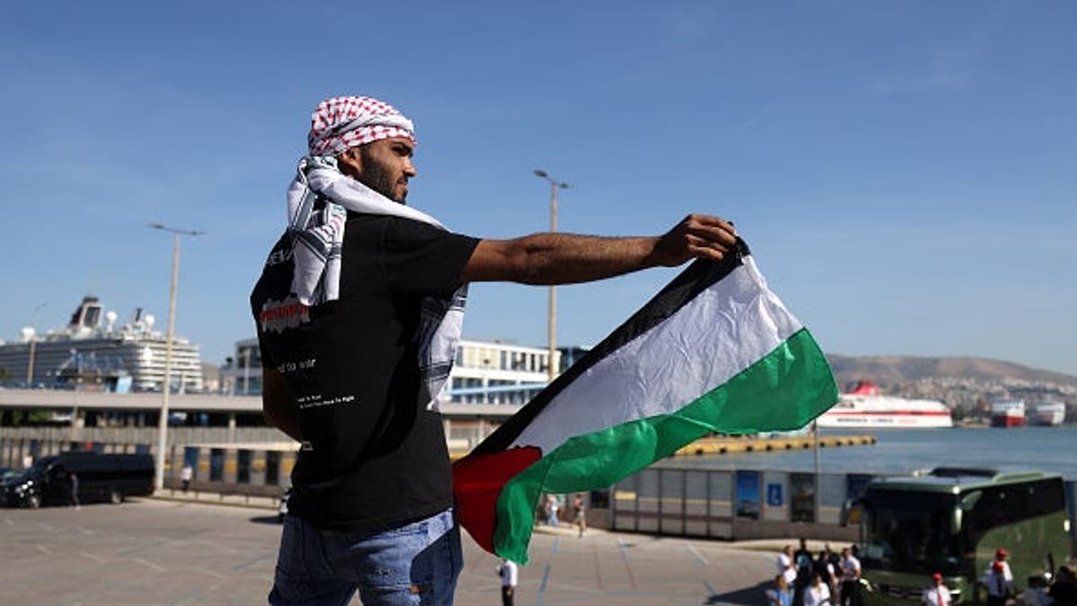 People take part in a protest against the arrival of the 'Crown Iris' cruise ship carrying Israeli tourists, in the port of Piraeus, near Athens, Greece, on June 3, 2026.