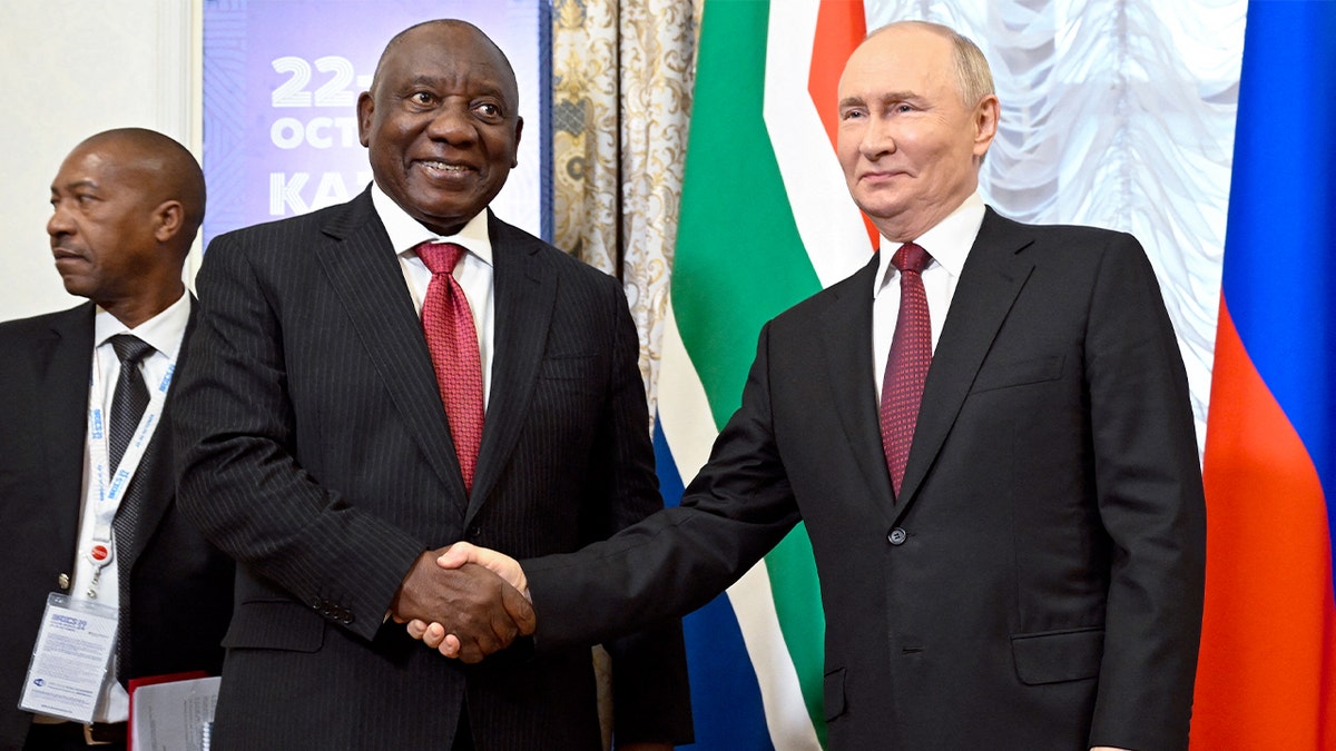 Vladimir Putin and Cyril Ramaphosa sit across from each other during a bilateral meeting at the BRICS summit in Kazan.