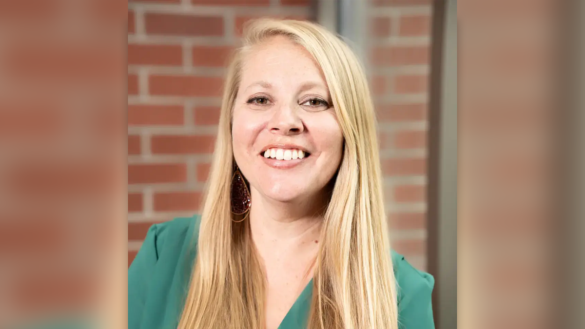 University of Idaho history chair Rebecca Scofield has long blonde hair and a green shirt on in this portrait