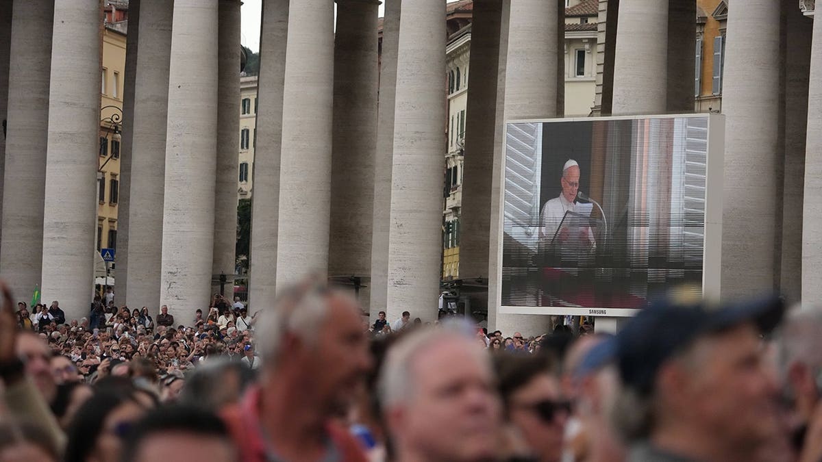 Pope Leo XIV appears at a window of the Apostolic Palace overlooking St. Peter's Square.