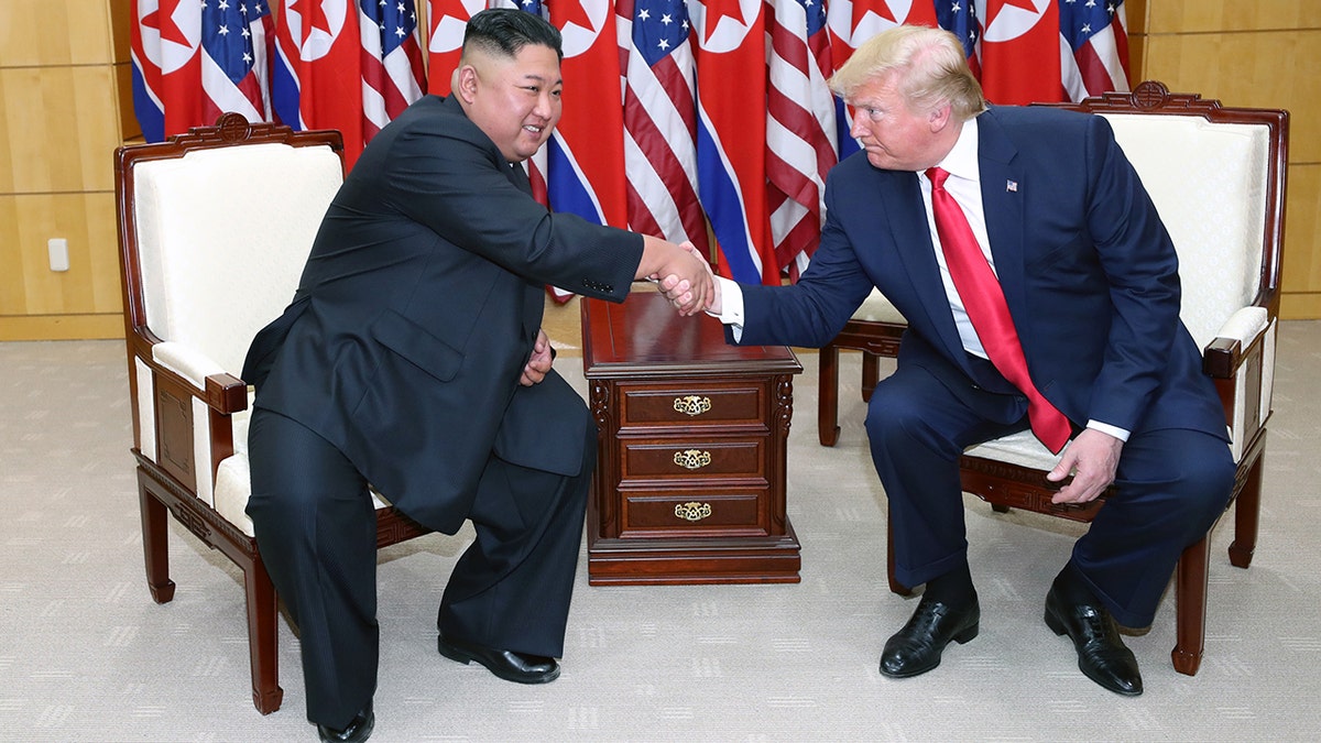 North Korea's Kim Jong Un shakes hands with U.S. President Donald Trump