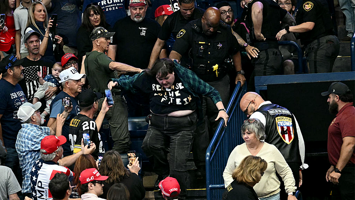 Heckler being escorted from a Trump rally
