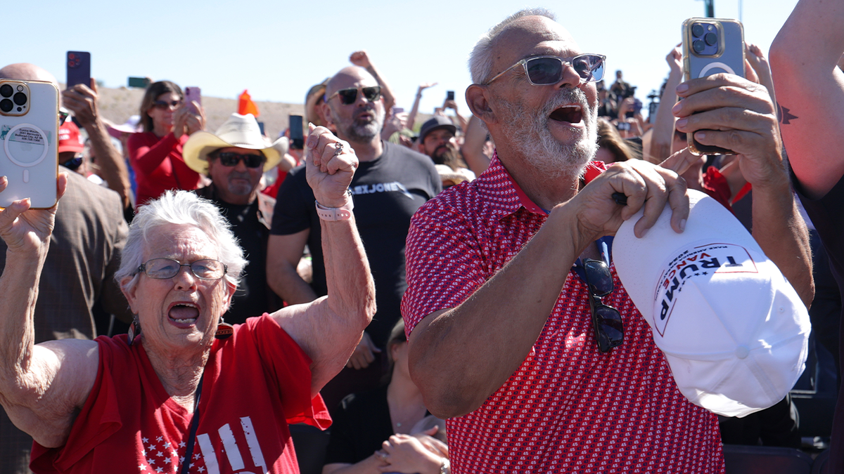 Trump supporters cheer and hold up phones during a campaign rally in Bullhead City, Arizona