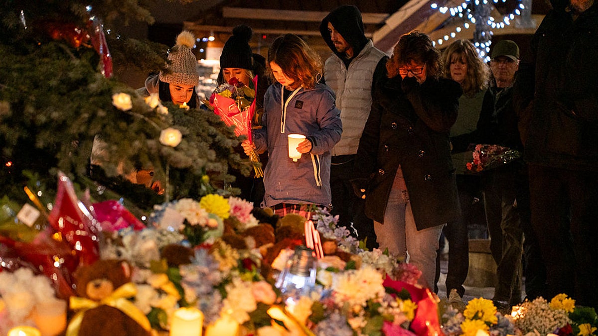 Community members mourn during a candlelight vigil for the victims of Tumbler Ridge Secondary School where a mass shooting took place a day earlier in the small town of Tumbler Ridge, British Columbia, on February 11, 2026.