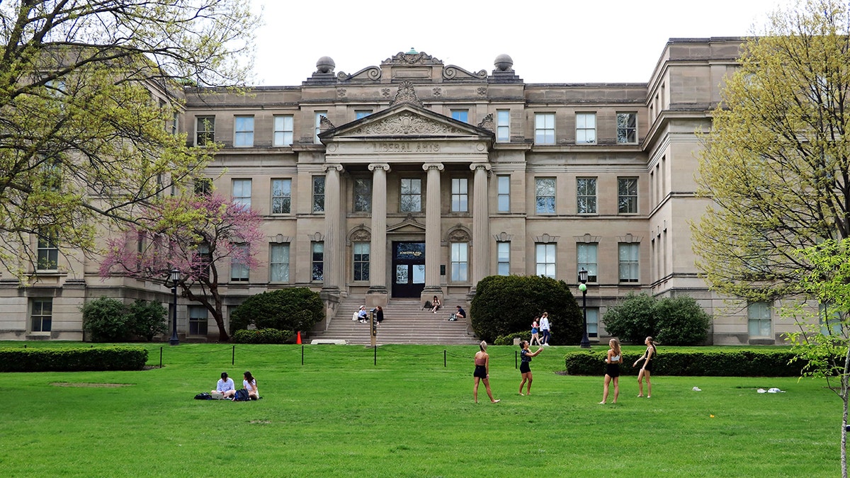 University of Iowa students outside on a lawn during spring in Iowa